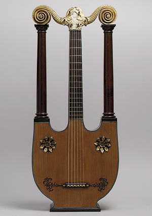 Lyre Guitar. 1805.''The lyre-guitar is an instrument that dates to at least the first century A.D., but was revived and popularly manufactured in France around 1785 during the Neoclassical period. Renaissance paintings by Lorenzo Costa and Raffaellino Garbo show lyre-guitars held upright (possibly interpretations of incised strings in classical bas-reliefs), as they were properly held by the player. Essentially, the lyre-guitar was a modified version of the lyre of antiquity, but with a fingerboard and six strings. English lyre-guitars were sold from 1811 as the six-string "Apollo" lyre of Edward Light and the twelve-string "Imperyal Lyre" of Angelo Benedetto Ventura.''