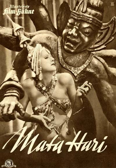 ''The stage is dominated by a statue of Shiva. As the lights go down, a woman emerges from the wings dressed in oriental costume; veils, a metal breastplate and elaborate jeweled headdress. She dances for Shiva, writhing around the statue in a suggestive and impassioned manner. ''
