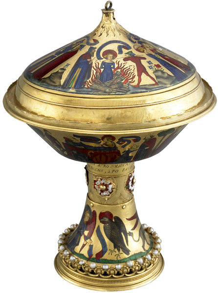 The Royal Gold Cup of the kings f England and France.''Agnes was imprisoned in a brothel as punishment for refusing to marry Procopius, son of the prefect Sempronius, in the time of the Emperor Constantine (reigned AD 306-337). She subsequently restored Procopius to life when he was strangled by a demon. Although he was repentant, Agnes was not spared her fate, and was condemned to burn. However, the flames had no effect on her, and she had to be killed with a spear. The cover of the cup is devoted to this section of the story, with each scene explained by a Latin inscription.'' British Museum