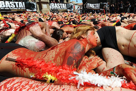 ''Animal rights activists gathered in the Spanish town on Las Ventas, for a very original protest against the famous bull fights held there.  Organized by Equanimal, the protest had the participants strip to their underwear, lie down and cover themselves with fake blood, and corrida spears. It took place at the end of May and hoped to convince authorities that the Spanish people no longer support such a cruel and barbaric tradition as bullfighting.''