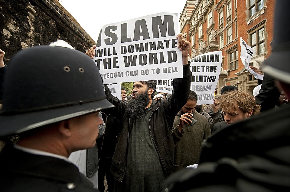 ''Protesters rallied as anti-Islamic Dutch lawmaker Geert Wilders held a news conference in London Friday. Mr. Wilders, who made a controversial film about Islam, arrived in London after a ban against him entering Britain was overturned.''