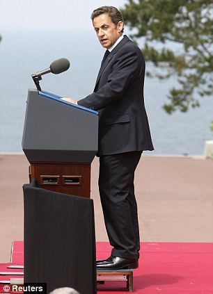 Sarkozy stands on a platform while speaking at the 65th anniversary of D-Day at the Normandy American Cemetery in Colleville-sur-Mer in June  Read more: http://www.dailymail.co.uk/news/