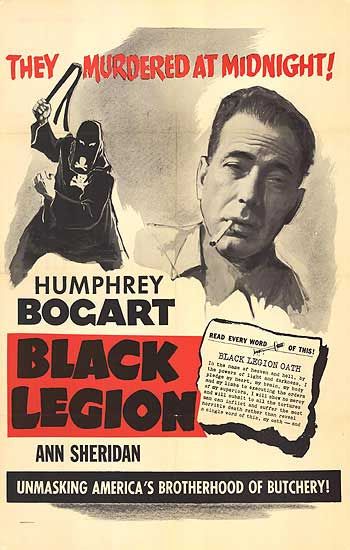 '' Frank is passed over in favour of workmate Joe Dombrowski (Henry Brandon). Burning over with resentment, Frank is approached by another worker in the factory, Cliff Summers (Joe Sawyer), who whips up his anger against “foreigners” and invites him to a secret meeting. He goes along, to see a crowd being whipped up by a demagogue speaking in something of a Hitler-style in a meeting room behind the local chemist’s shop – and agrees to join the group.''