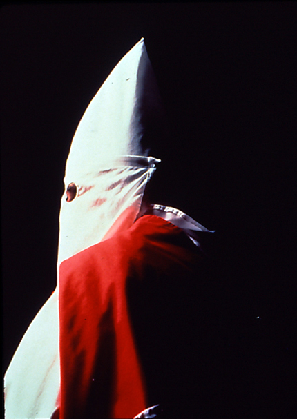 ''In "Klansman (Grand Dragon of the Invisible Empire)", a man becomes a horrifying figure, the mere shape of his hood is terrifying and that is why I have always found this series of images by Andres Serrano intriguing.  Its subject is a human but it is also a symbol of a dark and hateful history.  By documenting it in such a striking manner, Serrano confronts us with this hate and we must address it.''