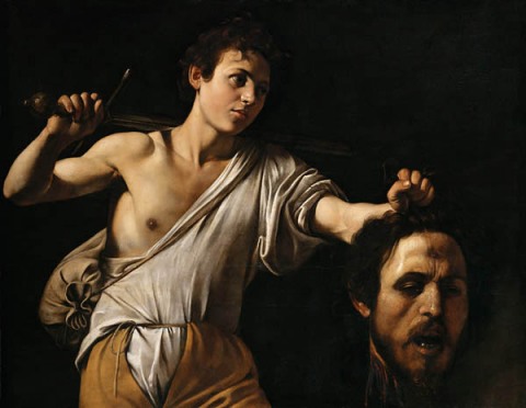 'And finally, in the last year of Caravaggio’s life.  After living for three years with the knowledge he killed a man, Caravaggio makes a pivotal artistic change.  In his two previous paintings of David and Goliath, Goliath is likely modeled after someone else (more so in 1599 than in the post-homicide 1607 version).  In Caravaggio’s final depiction of David & Goliath in 1610, David lifts up the “monster” Goliath’s severed head – revealing the monster to clearly be himself.  Caravaggio paints himself as both David and Goliath.  The source of the innocence, courage, and aspirations of youth reveals the head of his older, ”fallen” self."