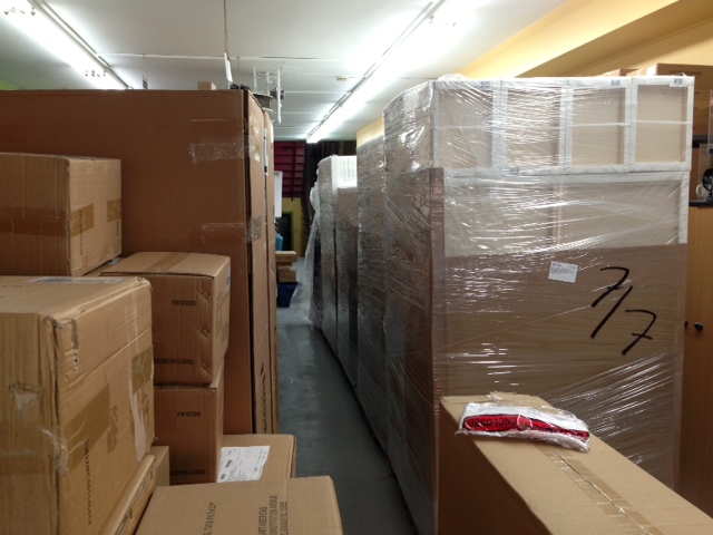 When the goods arrive, its all hands on deck to unload these monster pallets that usually surpass the limit of seven feet.