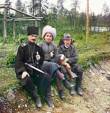 --- Sergei Mikhailovich Prokudin-Gorskii , Russian photographer, 1915 Colour picture with three-colour seperation technique. Prokudin-Gorskii is sitting on the right next to two gentlemen in Cossack dress. His rucksack is filled with photographic equipment.---click image for source...
