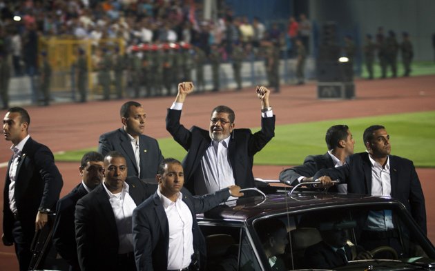 ---Associated Press/Khalil Hamra – Egyptian President Mohammed Morsi waves to the crowd gathered in a stadium upon his arrival for a speech on the 6th of October national holiday marking the 1973 war with Israel, ---click image for source...