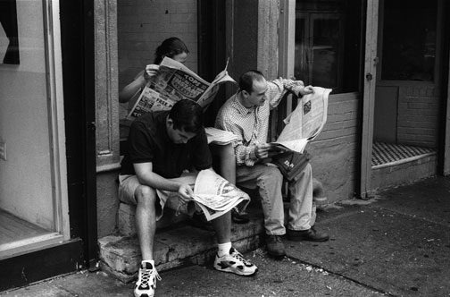 ---Here, we have three people sitting in a doorway, each one engrossed in reading a newspaper. It looks like a tight fit, but they seem quite comfortable. I'm sure they were aware of each other's presence, but the photograph "works" because they don't seem to be.   As I thought about this photograph, and others, sentences came to mind from "The Aesthetic Method in Self-Conflict," a chapter from Self and World by Eli Siegel....click image for source...