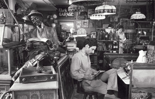 ---André Kertész - Second Avenue, New York (man reading in antique store), June 1969---
