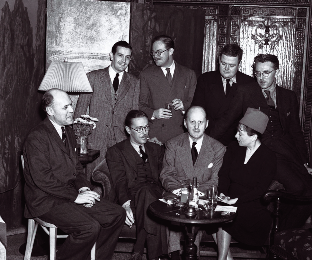 ---While writing theater crticism for Vanity Fair, Parker, Robert Benchley and Robert E. Sherwood begin a series of luncheon salons at the nearby Algonquin Hotel.    A 1938 book party at the Algonquin Hotel: seated, left to right, Fritz Foord, Wolcott Gibbs, Frank Case and Dorothy Parker; standing, Alan Campbell, St. Clair McKelway, Russell Maloney and James Thurber.---click image for source...