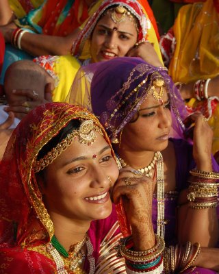 Rajasthan is a large and arid state in the Northwest with its own variety of folk dances. The bulky jewelry here is more than mere adornment for the occasion; it is tangible evidence of the family's wealth, representing not only the dowry but whatever they have been able to add to it since...click image for source...