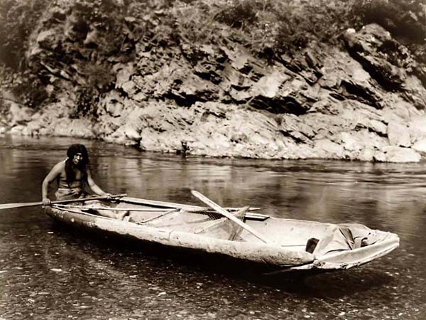 ---You are looking at a amazing picture of a Yurok Canoe On the Trinity River. It was created in 1923 by Edward S. Curtis. The picture presents an indian man paddling a canoe in a stream.---click image for source...